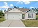 Charming single-story home featuring a two-car garage, well-maintained lawn, and welcoming curb appeal at 87 Royal Meadow Dr, Angier, NC 27501