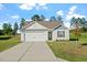 Inviting single-story home with a manicured lawn, concrete driveway, and a classic facade at 87 Royal Meadow Dr, Angier, NC 27501