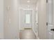 Bright hallway featuring neutral walls, hardwood floors, recessed lighting, and a glass-paneled door at 87 Royal Meadow Dr, Angier, NC 27501