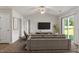 Cozy living room with plush sofa, tv, and access to the backyard at 87 Royal Meadow Dr, Angier, NC 27501