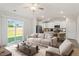 Bright, open-concept living room with neutral tones and a modern kitchen at 87 Royal Meadow Dr, Angier, NC 27501