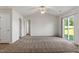 Spacious main bedroom with a ceiling fan, plush carpeting, and sliding glass doors to the outside at 87 Royal Meadow Dr, Angier, NC 27501