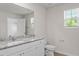 Well-lit bathroom with granite countertops and window at 94 Taverners Ln, Angier, NC 27501