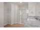Bathroom features granite countertops, shower with sliding glass doors and shelving unit at 94 Taverners Ln, Angier, NC 27501