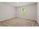 Bedroom with carpet, white walls, and a single window at 94 Taverners Ln, Angier, NC 27501