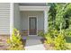 Close up view of home's front door with stone accents and well-kept landscaping at 94 Taverners Ln, Angier, NC 27501