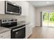 Kitchen with stainless steel appliances and lots of natural light at 94 Taverners Ln, Angier, NC 27501