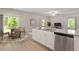 Open kitchen and dining area featuring stainless steel appliances and granite countertops at 94 Taverners Ln, Angier, NC 27501
