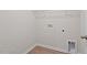 Laundry room featuring vinyl plank flooring, white walls, and utility connections at 94 Taverners Ln, Angier, NC 27501