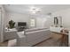 Bright living room featuring neutral walls, plush carpeting, and a ceiling fan at 94 Taverners Ln, Angier, NC 27501