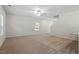 Spacious living room with plenty of natural light and neutral carpeting at 94 Taverners Ln, Angier, NC 27501