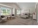 Bright main bedroom featuring sitting area with large windows and neutral decor at 94 Taverners Ln, Angier, NC 27501