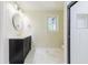 Bright bathroom featuring a black vanity with gold hardware and walk-in shower at 944 Athens Dr, Raleigh, NC 27606