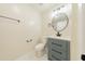 Bathroom featuring a vanity with modern hardware and a round mirror at 944 Athens Dr, Raleigh, NC 27606