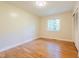 Well-lit bedroom featuring hardwood floors, neutral walls, and a bright window at 944 Athens Dr, Raleigh, NC 27606