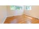 Bright bedroom with hardwood floors and natural light from a large window at 944 Athens Dr, Raleigh, NC 27606