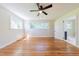 Large bedroom featuring hardwood floors, natural light, and a ceiling fan at 944 Athens Dr, Raleigh, NC 27606