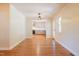 Open-concept dining area with hardwood floors offering a view into the modern kitchen at 944 Athens Dr, Raleigh, NC 27606