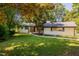 Charming one-story home with white brick exterior and landscaped front yard at 944 Athens Dr, Raleigh, NC 27606