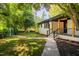 Charming one-story home featuring a walkway to the covered front porch and well-manicured yard at 944 Athens Dr, Raleigh, NC 27606