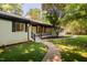 Charming one-story home featuring a walkway to the covered front porch and well-manicured yard at 944 Athens Dr, Raleigh, NC 27606