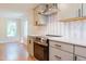 Modern kitchen featuring stainless appliances, gray cabinetry, and stylish backsplash at 944 Athens Dr, Raleigh, NC 27606