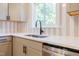 Close up of modern kitchen sink with white quartz countertops and gray cabinetry at 944 Athens Dr, Raleigh, NC 27606