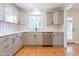 Updated kitchen with stainless steel appliances, white countertops, and modern gray cabinetry at 944 Athens Dr, Raleigh, NC 27606