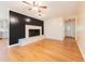 Cozy living room with a fireplace, hardwood floors, and seamless flow to the kitchen at 944 Athens Dr, Raleigh, NC 27606