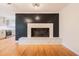 Spacious living room with a black accent wall and a decorative tile fireplace hearth at 944 Athens Dr, Raleigh, NC 27606