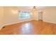 Spacious living room featuring hardwood floors, natural light, and modern lighting fixtures at 944 Athens Dr, Raleigh, NC 27606