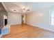 Bright living room with ceiling fan, hardwood floors, and a modern fireplace with marble accents at 944 Athens Dr, Raleigh, NC 27606