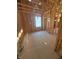 Bedroom under construction with exposed wood frame, and window view at 95 Bald Cypress Ln, Youngsville, NC 27596