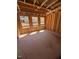 Bedroom under construction with exposed wood framing and windows at 95 Bald Cypress Ln, Youngsville, NC 27596