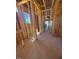 Unfinished interior with exposed framing and a distant window view at 95 Bald Cypress Ln, Youngsville, NC 27596