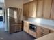 Kitchen with stainless steel refrigerator and custom wood cabinetry at 95 Bald Cypress Ln, Youngsville, NC 27596