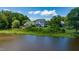 Aerial view of a beautiful home surrounded by lush greenery and serene water views at 9701 Corktree Ct, Wake Forest, NC 27587