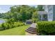 An expansive wooden deck with a hot tub and screened-in porch overlooking a lush green yard at 9701 Corktree Ct, Wake Forest, NC 27587
