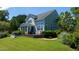 Expansive backyard with a hot tub, multi-level wood deck, screened porch, and lush landscaping at 9701 Corktree Ct, Wake Forest, NC 27587
