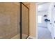 Bathroom showcasing a glass-enclosed shower and an adjacent walk-in closet with organized shelving at 9701 Corktree Ct, Wake Forest, NC 27587