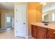 Vanity with wood cabinets, a white countertop, and a decorative mirror in the bathroom at 9701 Corktree Ct, Wake Forest, NC 27587