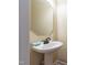 Pedestal sink and beveled mirror in the half bathroom at 9701 Corktree Ct, Wake Forest, NC 27587