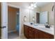 Double sink bathroom vanity with dark wood cabinets and a view of another room at 9701 Corktree Ct, Wake Forest, NC 27587