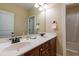 Bathroom featuring double sinks with dark wood cabinetry and a shower with a curtain at 9701 Corktree Ct, Wake Forest, NC 27587