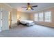 Large bedroom features neutral carpet, bench, walk in closet, and a ceiling fan at 9701 Corktree Ct, Wake Forest, NC 27587