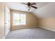 Bedroom features neutral paint, carpet, ceiling fan, and a large window at 9701 Corktree Ct, Wake Forest, NC 27587