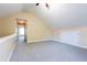Spacious bonus room with vaulted ceiling, neutral carpet, and great natural light at 9701 Corktree Ct, Wake Forest, NC 27587