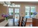 A dining area showcases lake views, a wood table, with a centerpiece of fresh flowers and natural light at 9701 Corktree Ct, Wake Forest, NC 27587