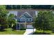 Charming exterior view of house near the water with stone facade at 9701 Corktree Ct, Wake Forest, NC 27587