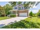 Charming two-story home with stone accents, a covered porch, and a two-car garage at 9701 Corktree Ct, Wake Forest, NC 27587